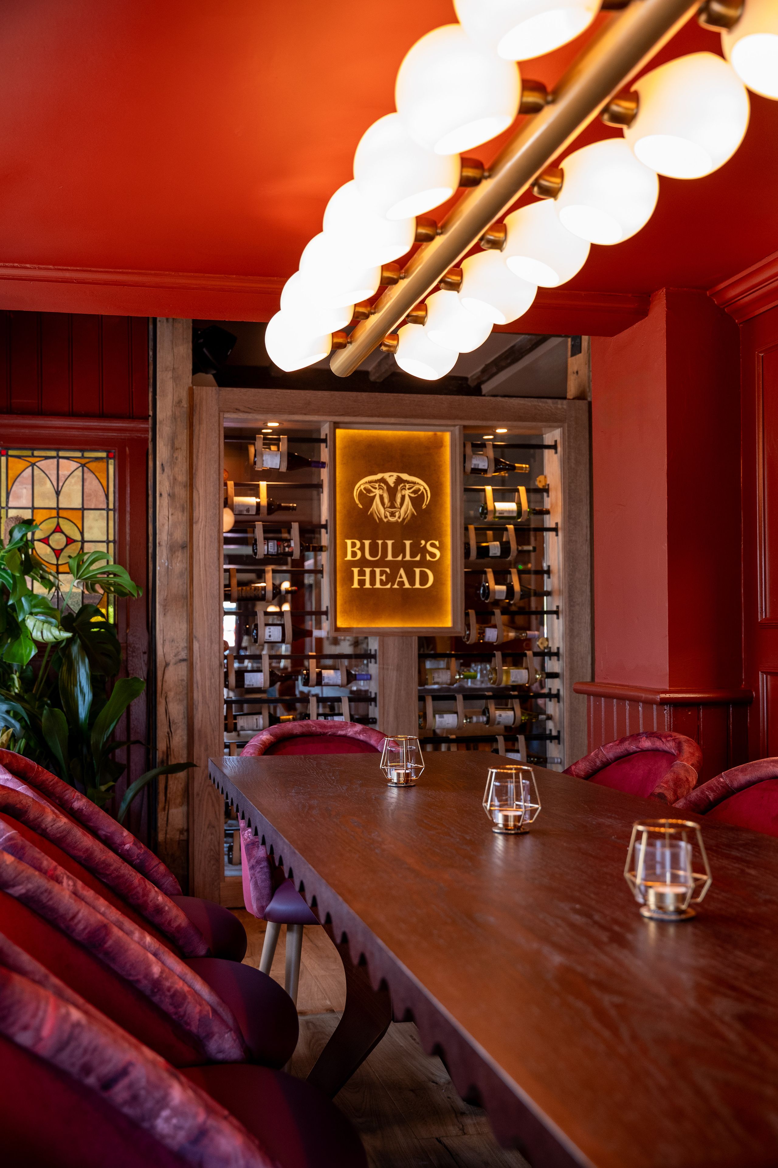 bulls head sign surrounded by wine cabinet in the bar