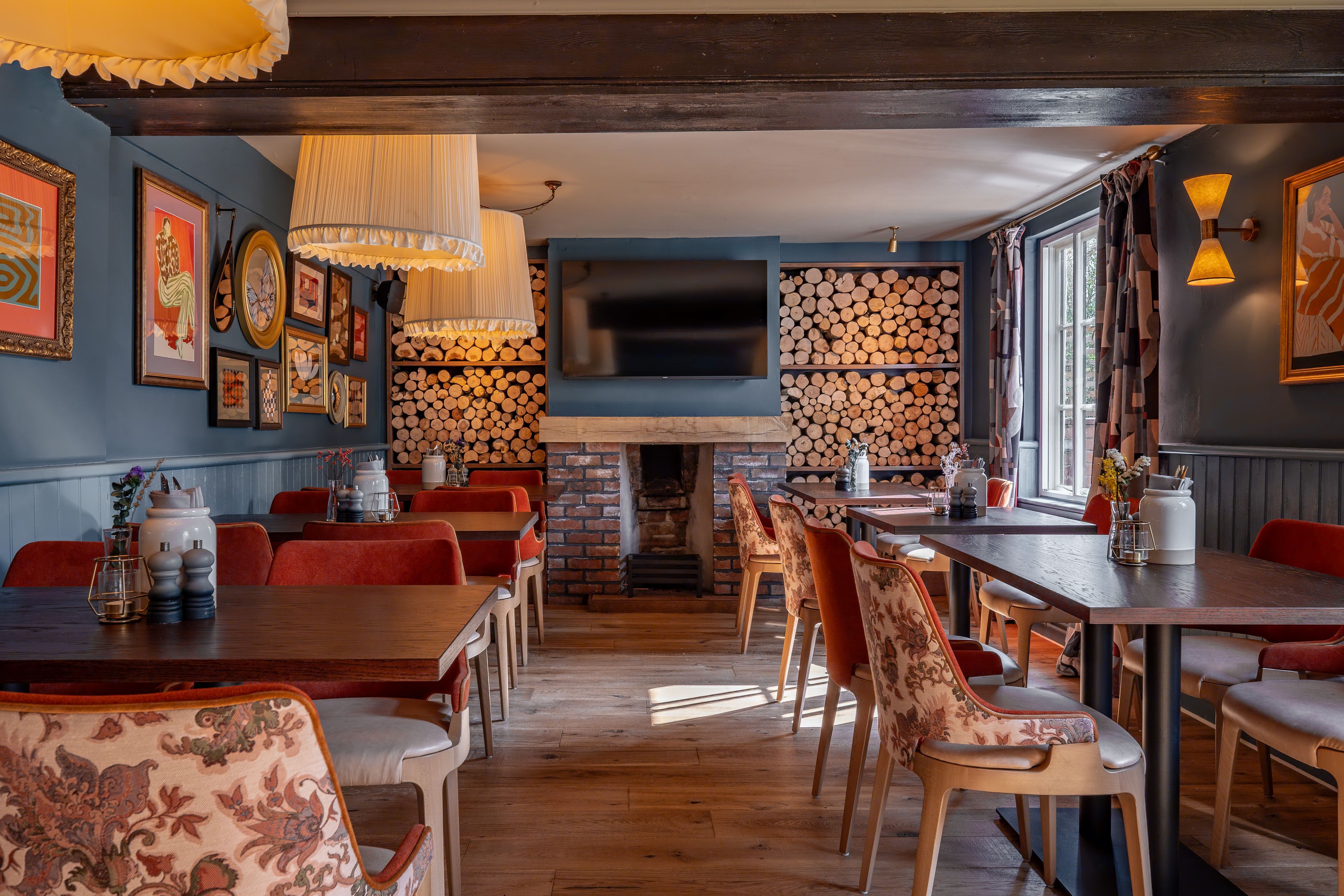 a seating area in the restaurant by the fire