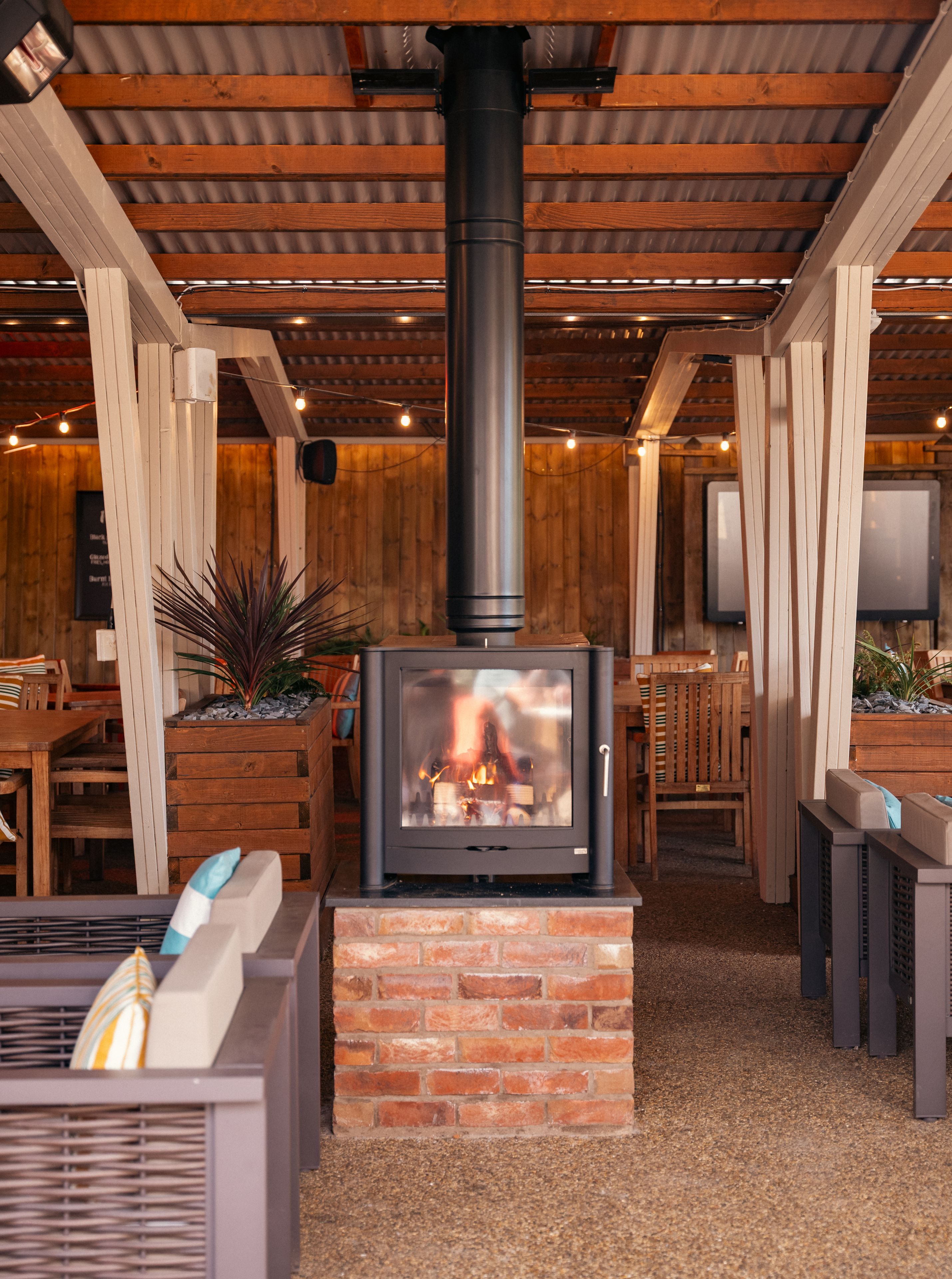 a cosy fire in the outdoor seating area